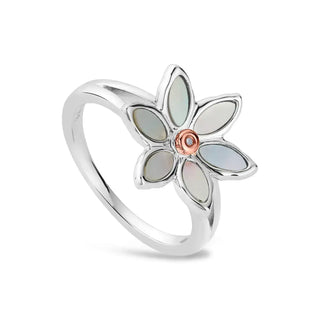 A silver ring with a floral lily design featuring mother of pearl petals and a central sparkling diamond.