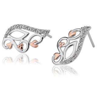 Silver and rose gold earrings with intricate designs on a white background