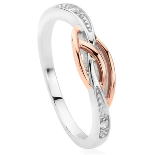 Two-tone ring with silver and rose gold design on a white background
