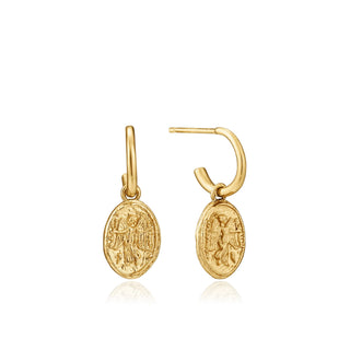 Gold earrings with intricate designs on a white background