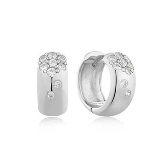 A pair of rhodium-plated sterling silver huggie hoop earrings with a cluster of sparkling cubic zirconia at the front.