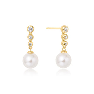 Pair of pearl earrings with gold and cubic zirconia accents on a white background