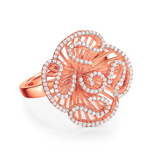 Rose gold ring with intricate design and small diamonds on a white background