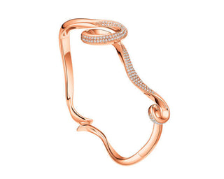 A rose gold bangle bracelet with cubic zirconia accents, part of the Serenity Collection.