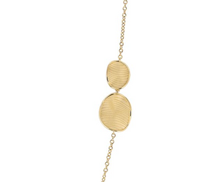 Gold necklace with two round pendants on a white background