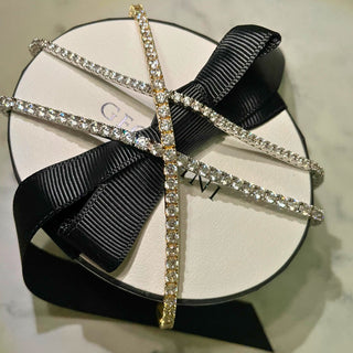 Earring with black bow and crystal details on a Givenchy box