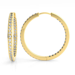 Gold hoop earrings with embedded czs on a white background