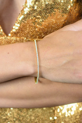 wrist wearing a Georgini gold plated silver 2m cz tennis bracelet