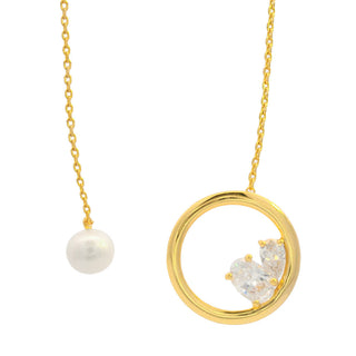 Gold necklace with a circular pendant featuring a pearl and floral design on a white background