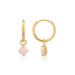 Gold plated silver hoop earrings with pink created opal stones on a white background