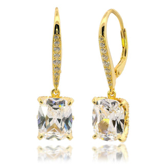 Gold earrings with clear gemstones on a white background
