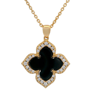 Gold necklace with a black clover-shaped pendant on a white background