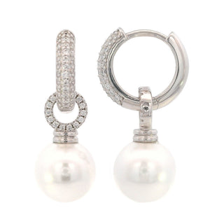 Pair of silver hoop earrings with pearl drops on a white background
