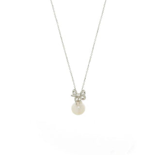 A delicate silver chain necklace featuring a small bow-shaped charm set with tiny clear stones and a single round white pearl pendant, shown against a plain white background.