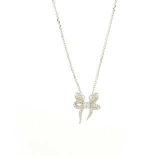 A delicate silver chain necklace featuring a small bow pendant paved with clear stones, displayed against a solid white background.