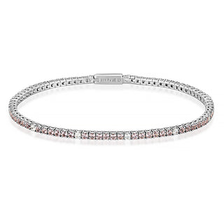 A silver tennis bracelet with a row of clear gemstones, featuring a visible 'Juby D' brand engraving on the clasp, set against a plain white background.