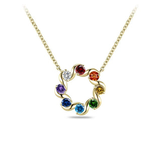 A gold chain necklace with a circular, swirled pendant set with multiple colorful gemstones in red, orange, yellow, green, blue, purple, and one clear stone, shown on a white background.