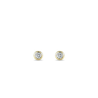 Gold earrings with clear gemstones on a white background