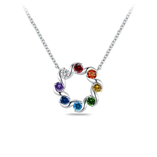 A silver-tone necklace with a circular open pendant featuring seven colorful gemstones in a rainbow sequence, set against a plain white background.