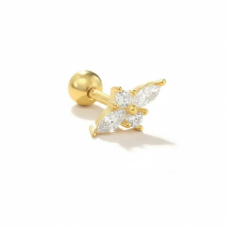 Gold cubic zirconia earring lying on its side