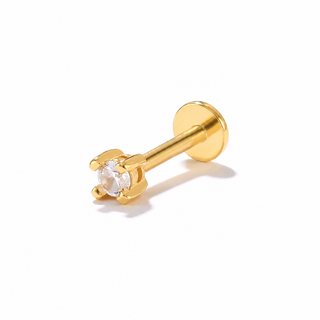 A gold labret stud earring with a clear round-cut gemstone in a four-prong setting, shown on a clean white background with a soft shadow.