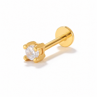 A gold-plated labret stud earring with a round-cut clear gemstone in a four-prong setting, shown on a clean white background.