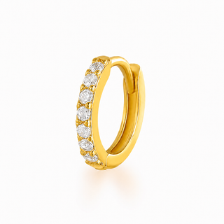A gold huggie hoop ring featuring a row of round-cut clear gemstones, shown on a clean white background.