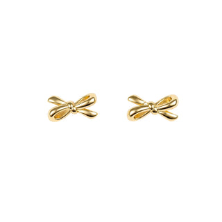 A pair of small polished gold bow-shaped stud earrings on a plain white background.