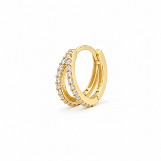 A gold huggie hoop earring adorned with small clear pavé stones along one of its curved bands, shown on a clean white background.