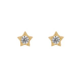 A pair of gold star-shaped stud earrings, each featuring a round clear gemstone in the center, set against a plain white background.