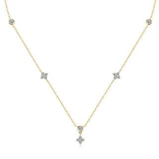 Gold necklace with diamond fleur accents on a white background
