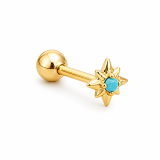 A gold-plated labret piercing stud featuring a starburst front design with a central turquoise cabochon stone, shown on a clean white background.