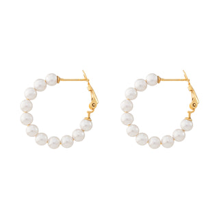 Pair of pearl hoop earrings with gold clasps on a white background