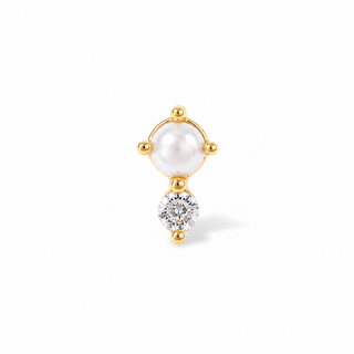 A delicate gold stud earring featuring a white freshwater pearl in a four-prong setting and a dangling clear round-cut gemstone below, set against a solid white background.