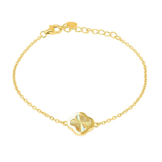 A delicate gold chain bracelet with a central gold clover-shaped charm featuring a sunburst pattern and a small iridescent inlay, displayed on a clean gray gradient background.