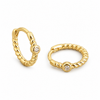 A pair of gold huggie hoop earrings with a twisted rope texture and a small round clear gemstone set in each earring, shown on a plain white background.