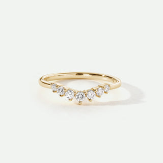Gold ring with diamonds on a light beige background