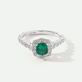 White Gold ring with a green gemstone on a white background