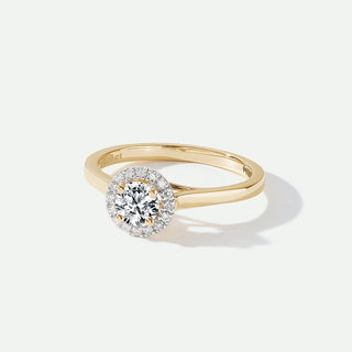 Gold ring with a diamond on a white background