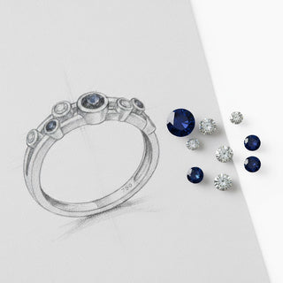 Sketch of a ring with loose sapphire anf diamonds lying next to it