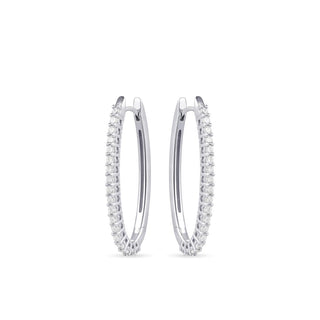 Pair of silver hoop earrings with embedded stones on a white background