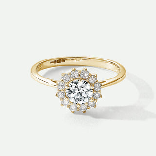 Gold ring with a diamond on a white background