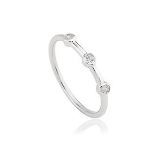 A trilogy ring with three white topaz stones set in a sterling silver band