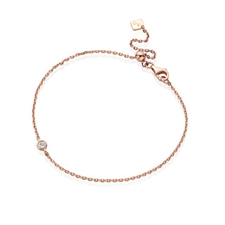 Rose gold bracelet with a small diamond on a white background