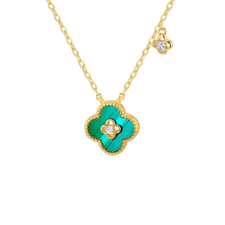Gold necklace with a green clover pendant on a white background