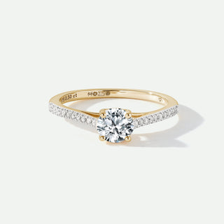 Gold ring with a diamond on a white background