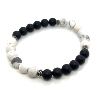 Bracelet with black and white beads on a white background