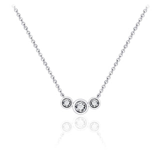 Silver necklace with three round gemstones on a white background
