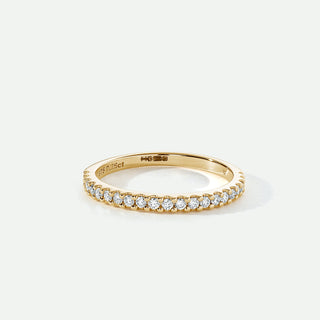Gold ring with diamonds on a white background