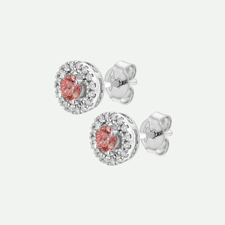 Silver earrings with pink gemstones on a white background
